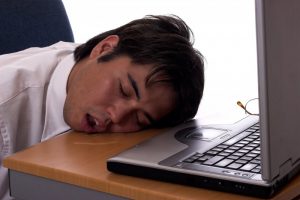 man sleeping at desk drooling