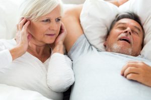 woman upset with husband snoring
