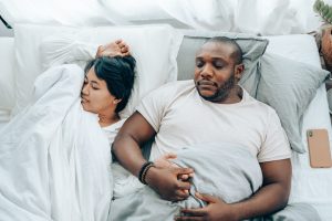 Couple holding hands while sleeping