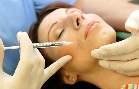 Dentist giving patient BOTOX injection