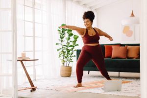 Young woman exercising in living room