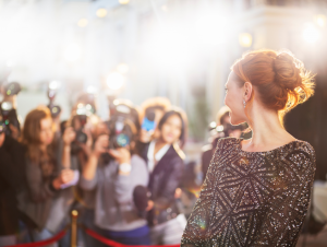 a celebrity smiling at paparazzi