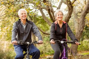 Happy senior couple riding bicycles