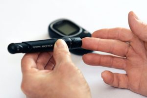 Man checking blood sugar level