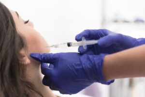Woman looking relaxed as she receives BOTOX injections in her jaw