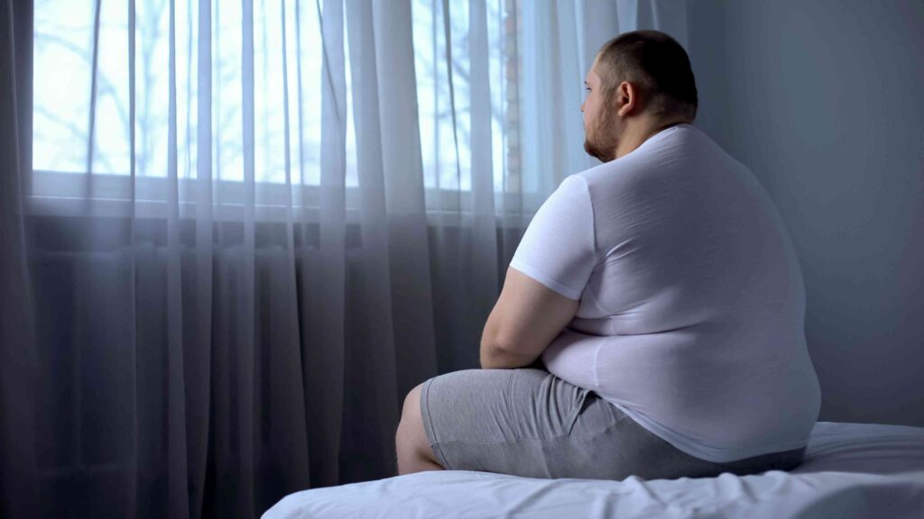 Man sitting on his bed