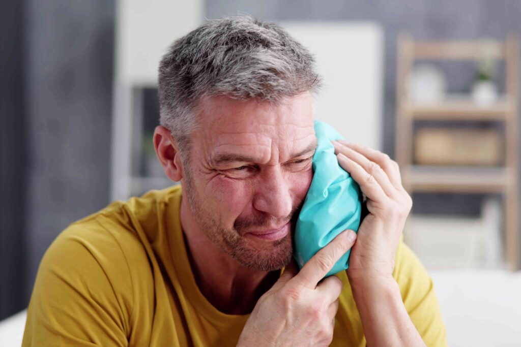 Man with a cold compress